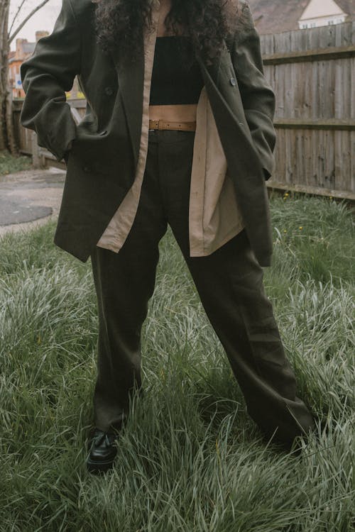 Woman in Suit Standing on Grass