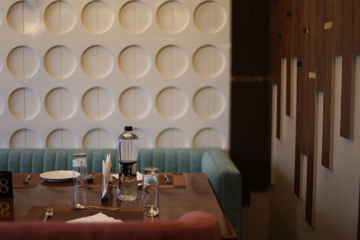 Sophisticated table setup in a modern restaurant with stylish wall décor and ambient lighting.