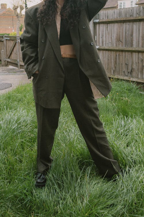 Woman in Green Coat Standing on Grass