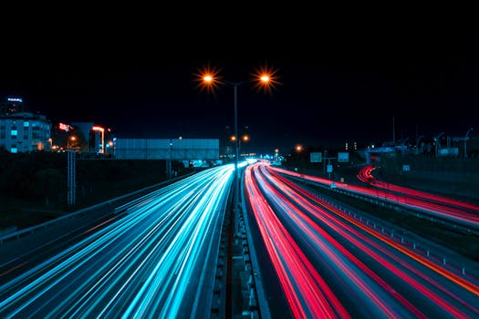 Captivating view of light trails on a city highway at night, showcasing urban life and motion.