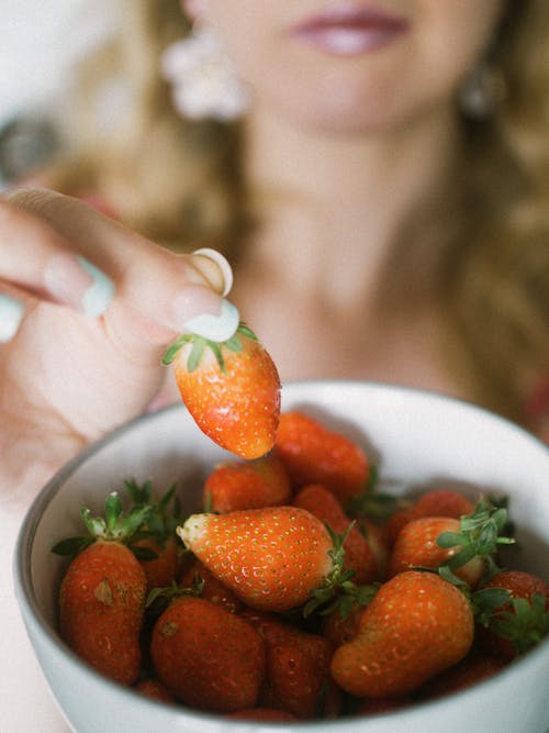 Woman Fingers Holding Strawberries