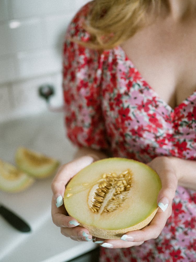 Woman Holding Half Of Melon