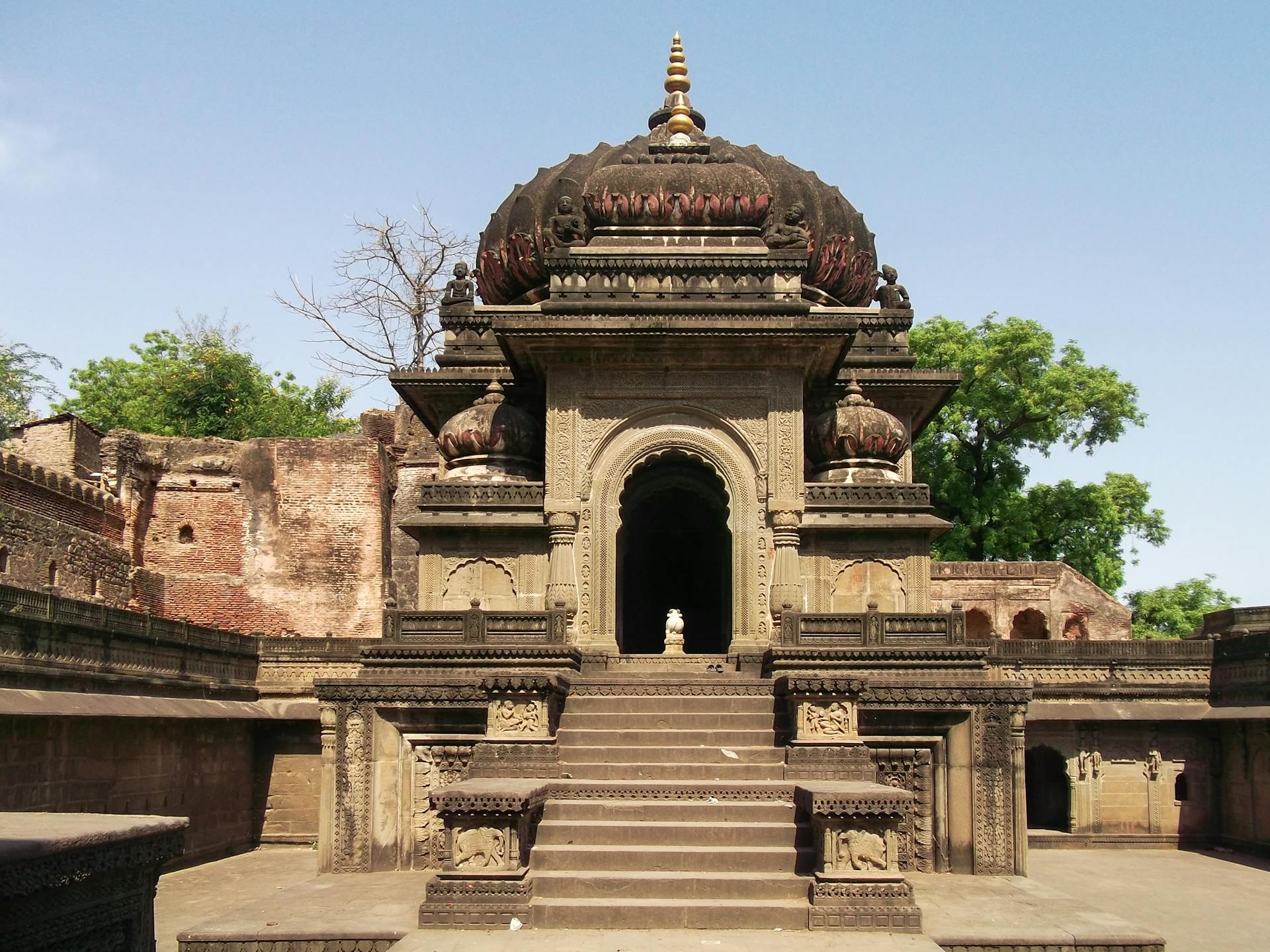 A stunning view of a historic Hindu temple showcasing intricate architectural details under a clear blue sky.