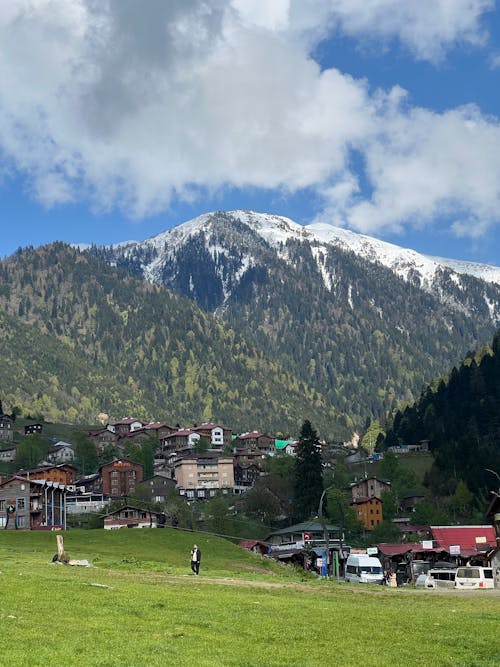 Scenic View of Snowcapped Mountains and a Village 