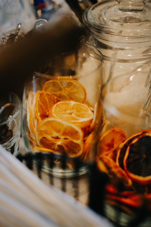 Free Elegant close-up shot of dried lemon slices in glass jars, perfect for food and beverage concepts. Stock Photo
