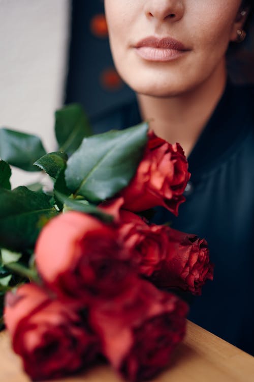 Free Woman with a Bouquet of Red Roses Stock Photo