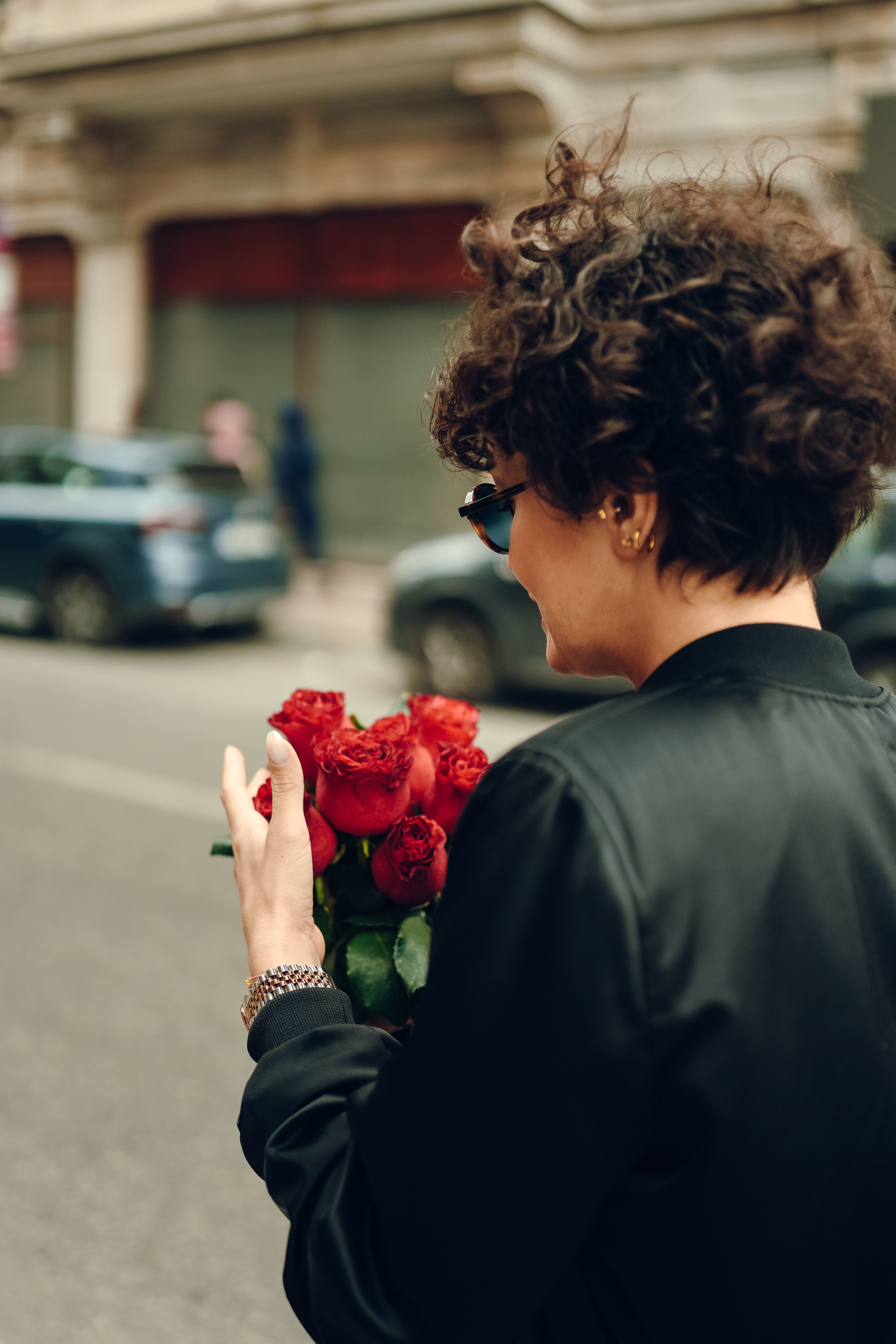 Person holding a romantic red rose bouquet