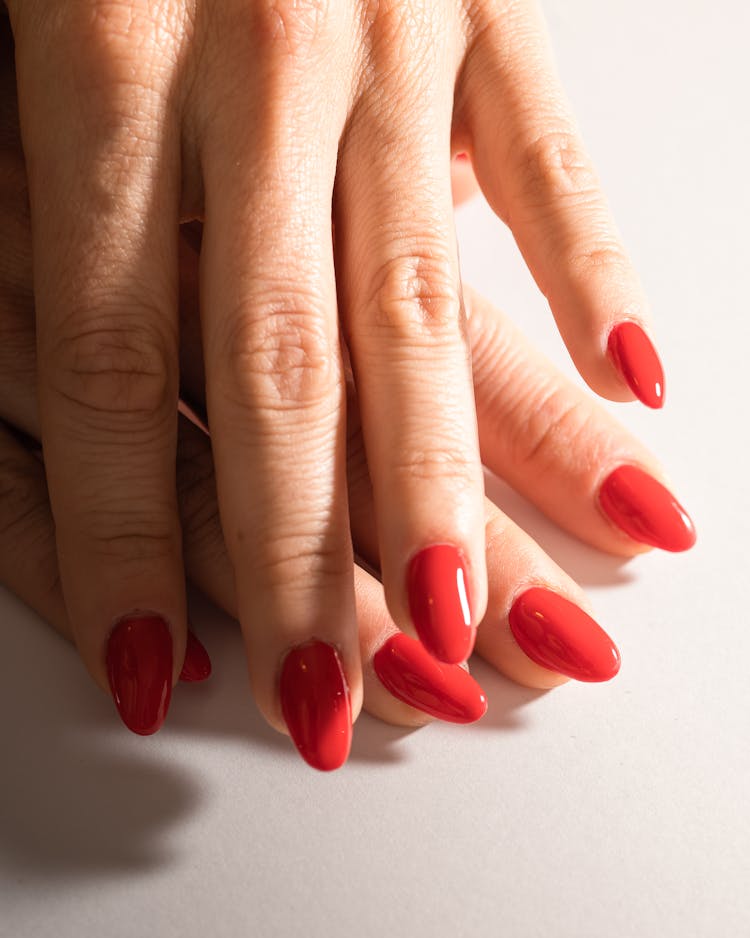 A Hand With Red Painted Nails