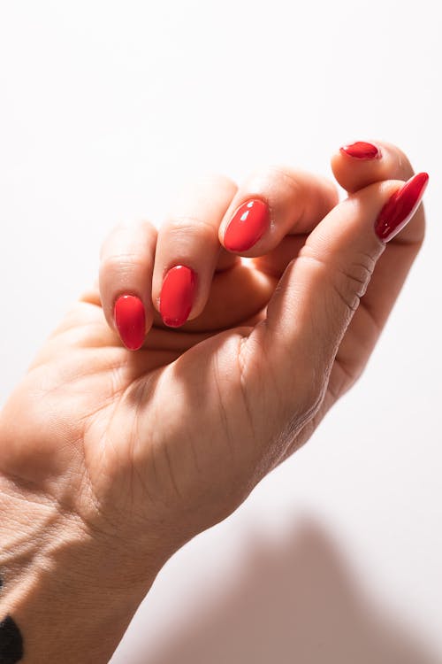 A Hand with Red Painted Nails