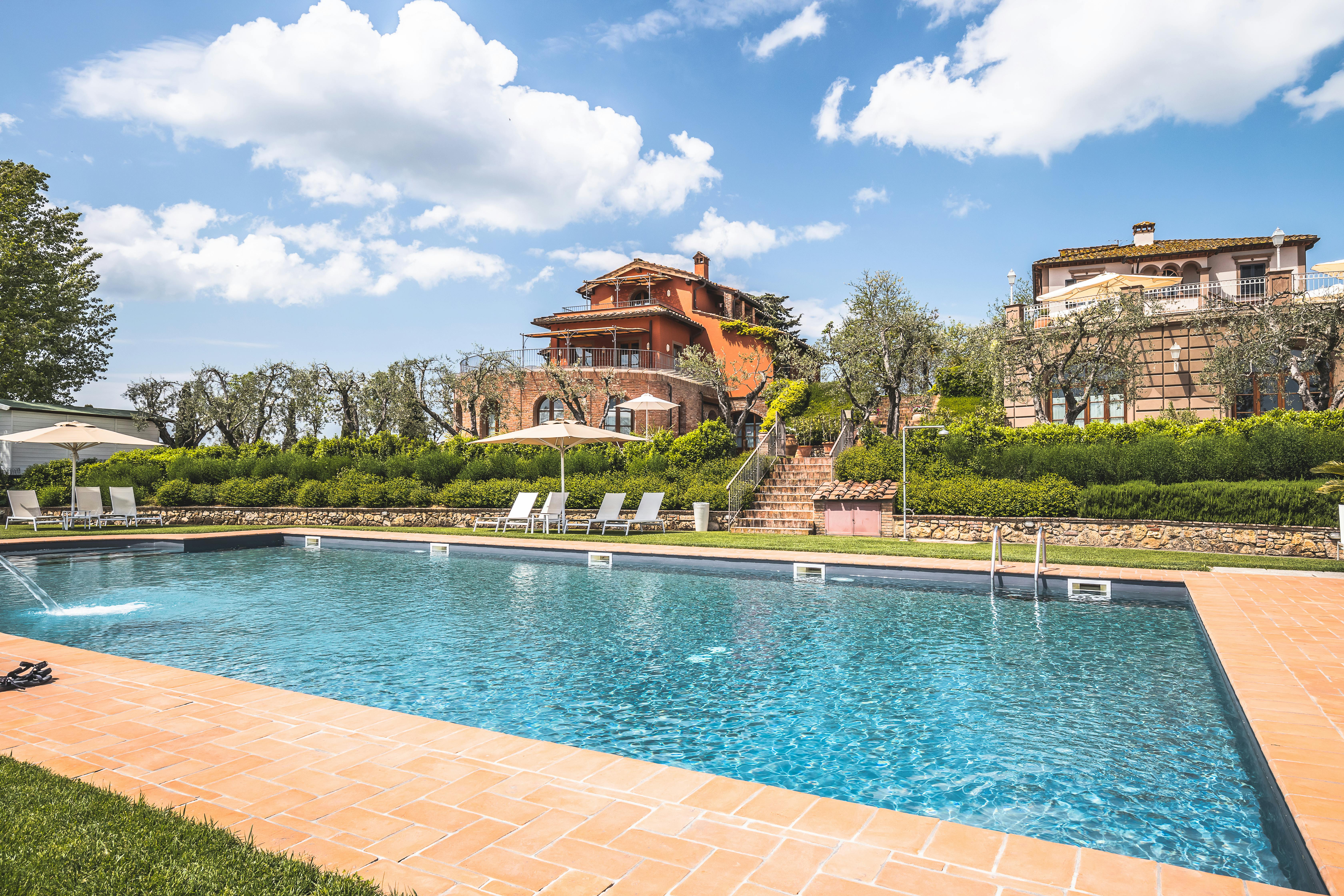 Stunning mansion with a pool and lush garden setting, ideal for summer vacations. - Photo by Andrea Mosti on Pexels
