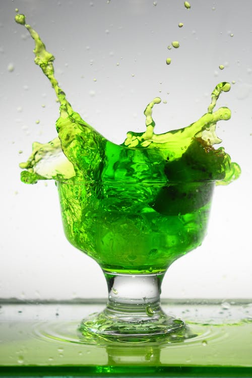 Kiwi Flavored Drink Splashed by an Ice Cube