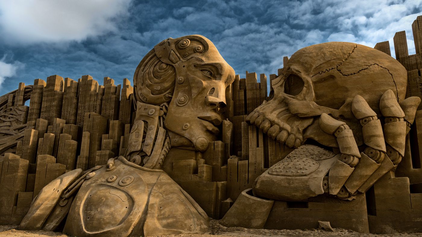 Intricate sand sculpture depicting a robot and skull in Ringkøbing, Denmark.