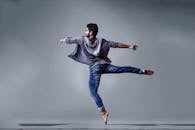 Man Wearing Blue Jeans Doing Pirouette Spin