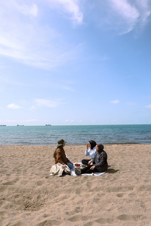 Free People Having a Picnic on a Beach Stock Photo