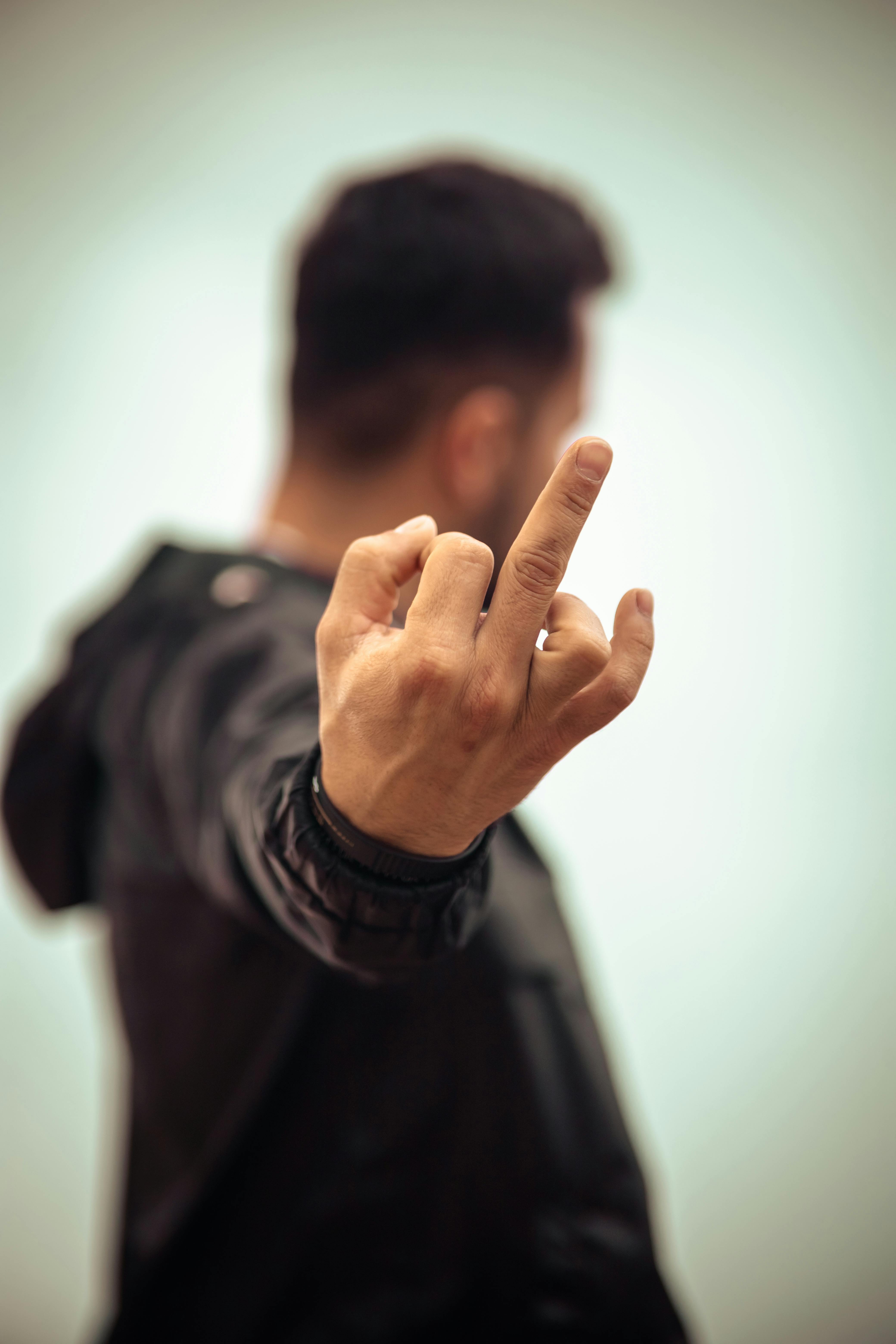Image Of Attractive Young Man Dressed In Black T-shirt Posing Over White  Background Showing Middle Finger To Camera. Stock Photo, Picture and  Royalty Free Image. Image 70421600.