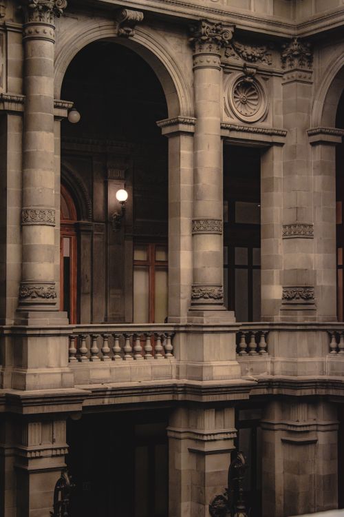 Free An elegant interior showcasing neoclassical architecture with detailed columns and pilasters. Stock Photo