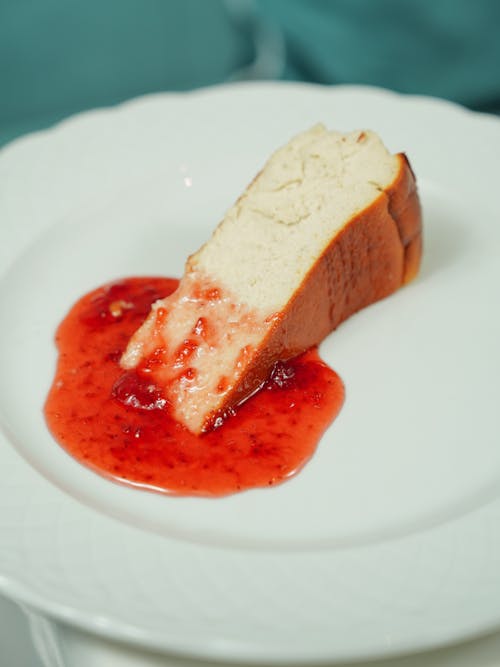 Free Piece of Cheesecake and Strawberry Jam  Stock Photo