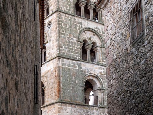 Free Close-up view of a medieval stone tower facade showcasing Gothic architecture with arched windows. Stock Photo