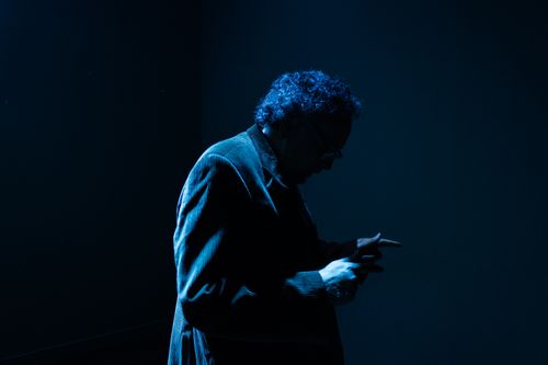 Free Silhouette of a man with curly hair in blue light creating a mysterious mood. Stock Photo
