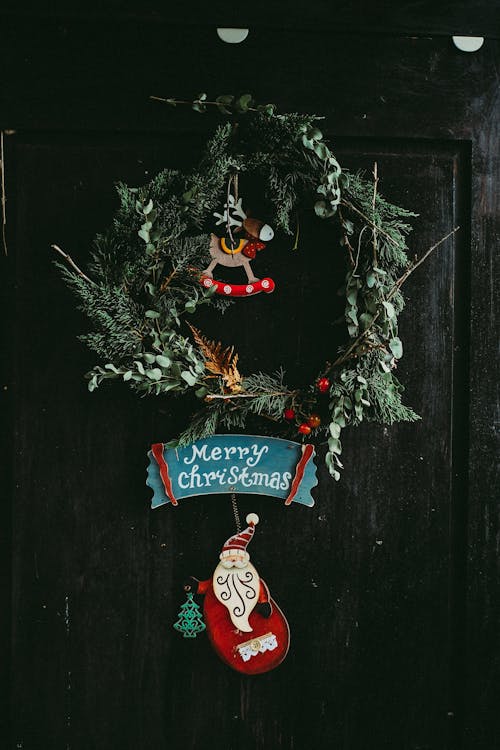 Free Green Christmas Wreath Hanging on Door Stock Photo