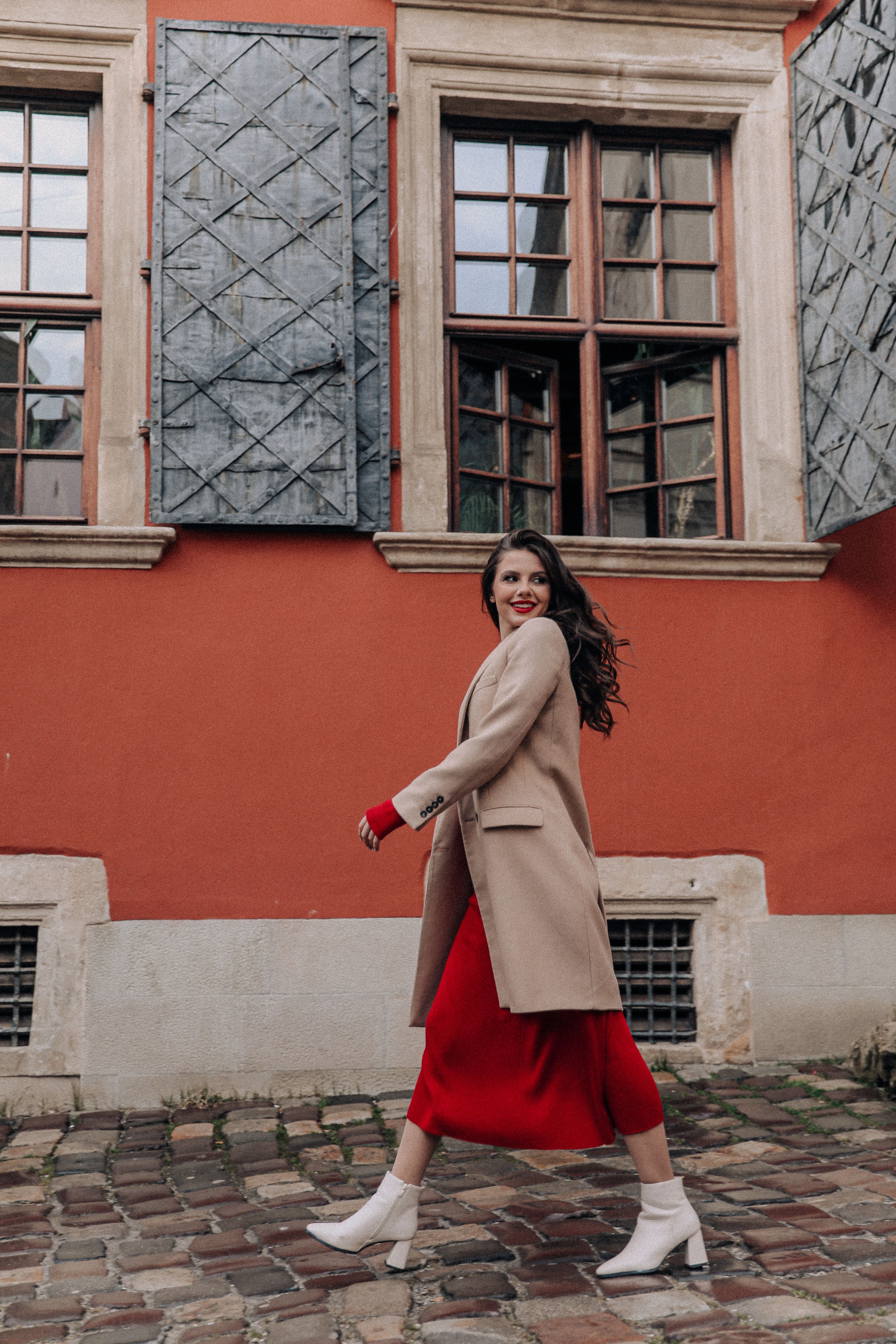 Woman in a Coat and Red Dress Walking in a City Free Stock Photo Woman in a Coat and Red Dress Walking in a City Free Stock Photo