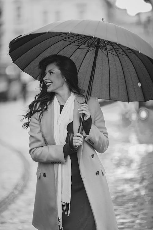 Smiling Woman Standing with Umbrella in Black and White