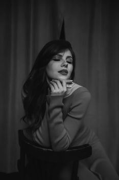 Captivating black and white portrait of a woman posing with closed eyes, exuding elegance and sensuality.