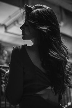 Grayscale image capturing a woman's elegance and sophistication.
