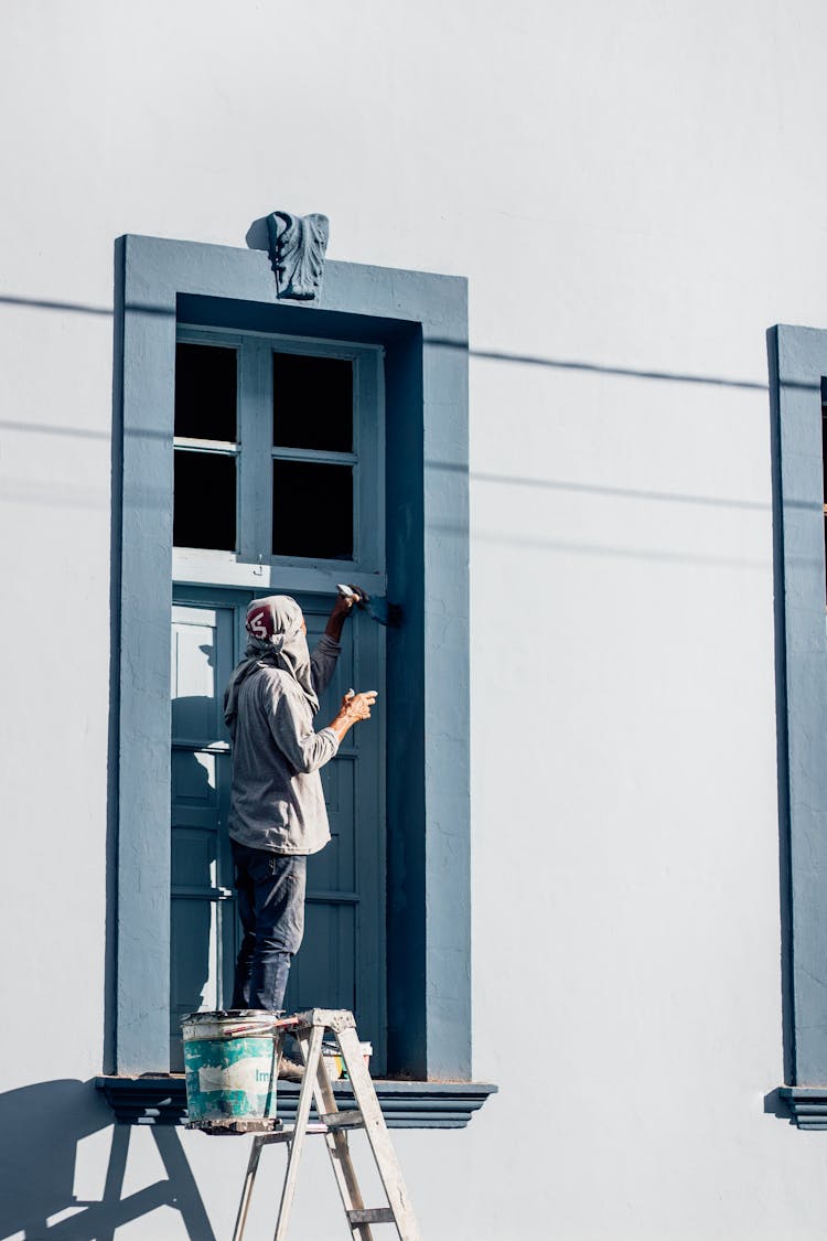 Man Painting Window Frame