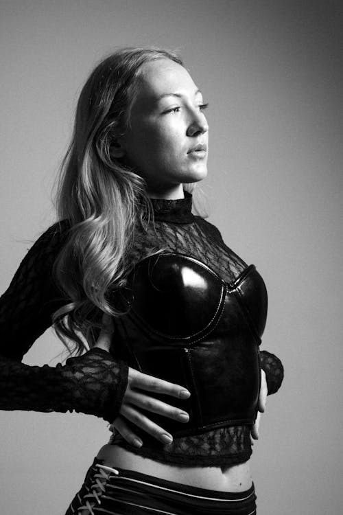 Woman Posing in Studio, Wearing Stiff Black Corset