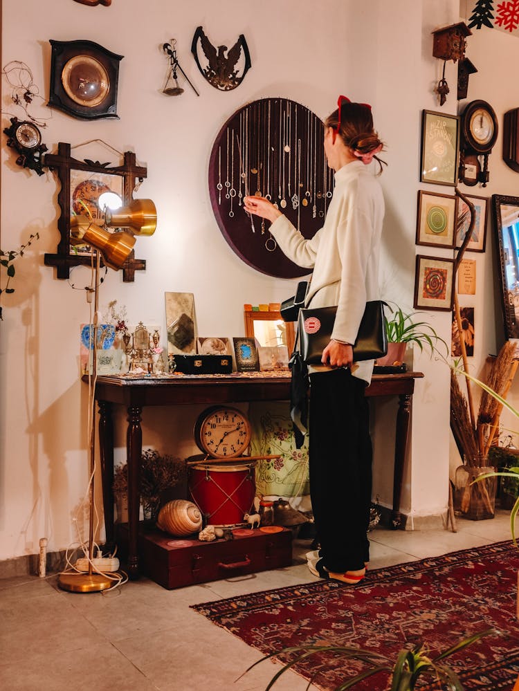 Woman In An Antique Store Looking At Chains 