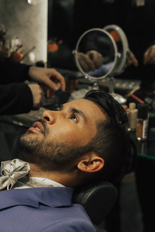 Man in Elegant Suit Sitting in Barbers Chair