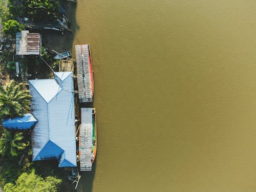 Birds Eye View of a House and Moored Tourist Boats 