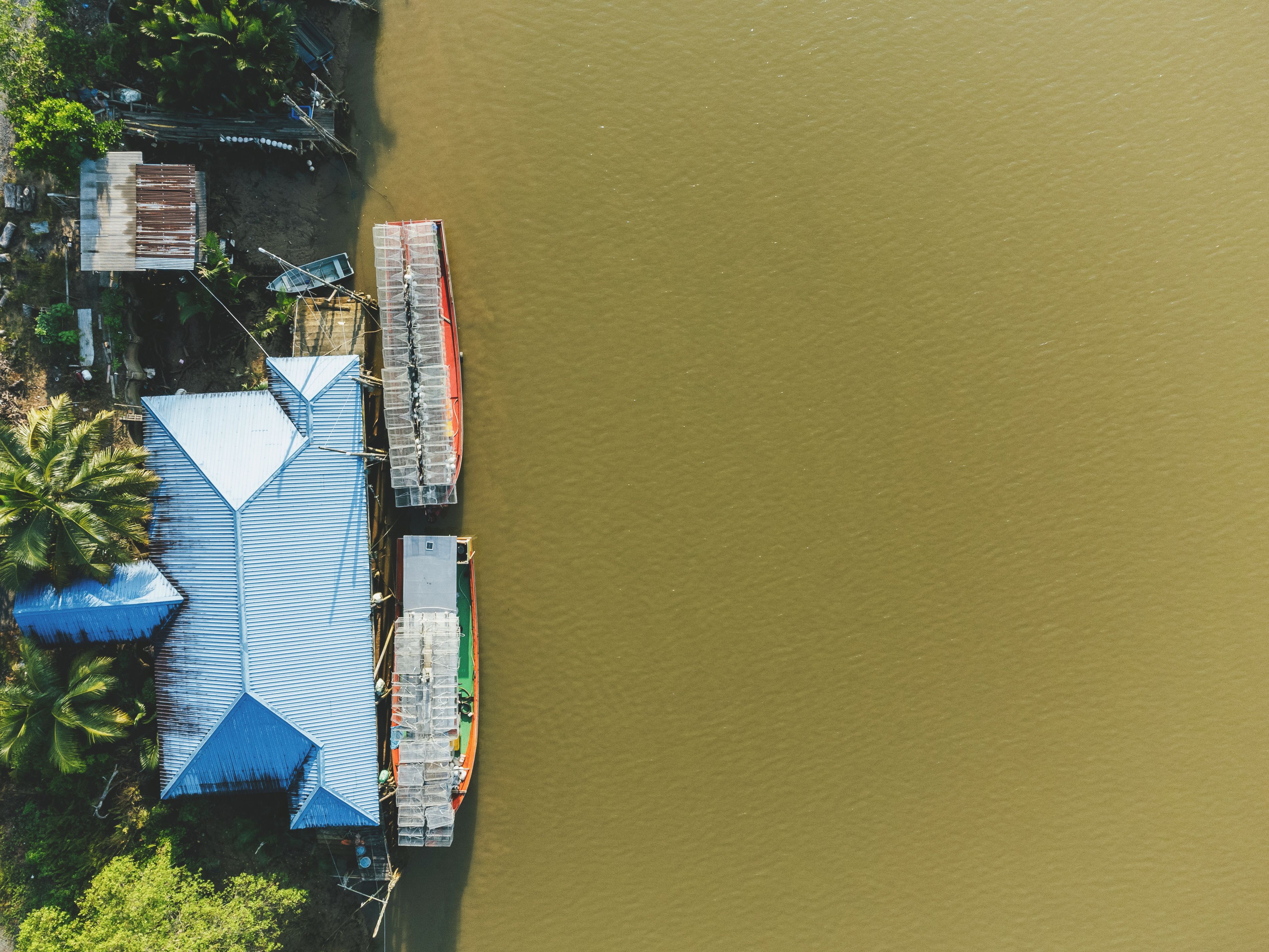 Birds Eye View of a House and Moored Tourist Boats · Free Stock Photo