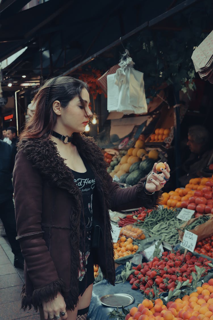 Brunette Woman Looking At Fruit At Market In Istanbul, Turkey