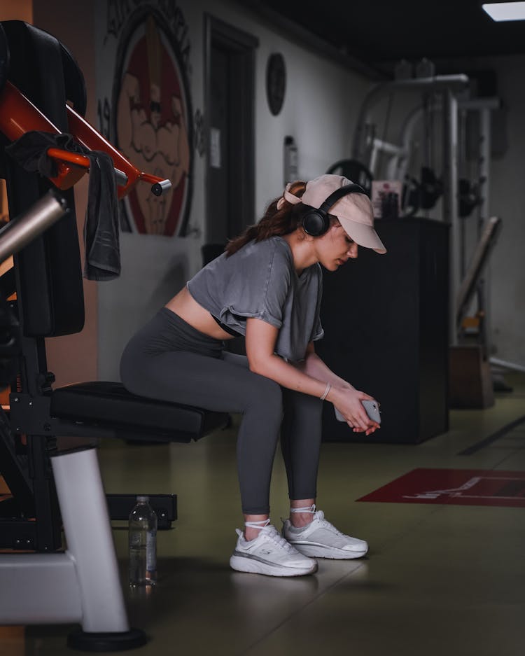 Woman With Headphones Resting At Gym