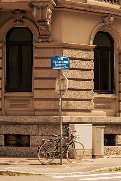 Bike Leaning on Post on Sidewalk in City