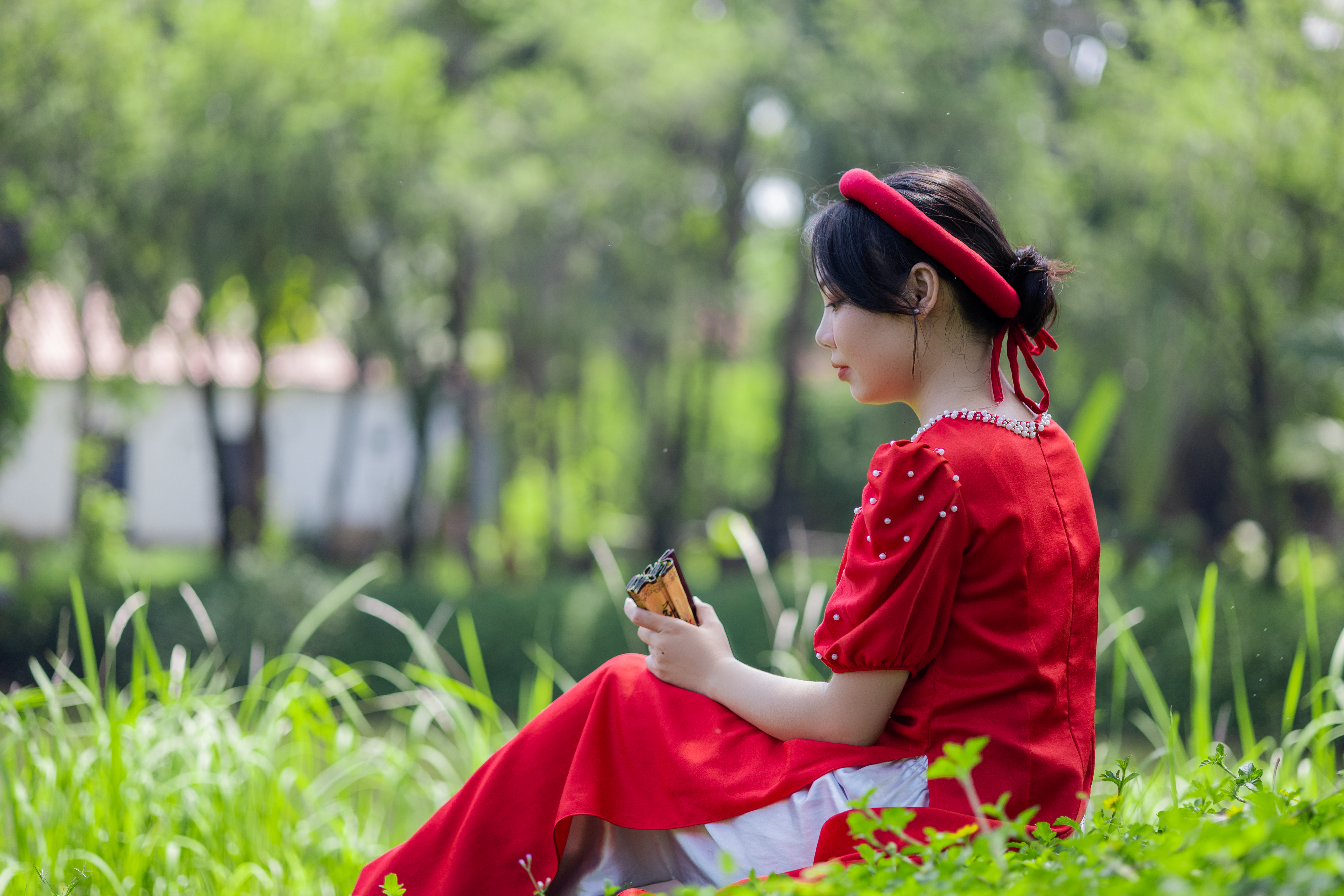 Woman in Traditional Clothing Sitting on Grass · Free Stock Photo