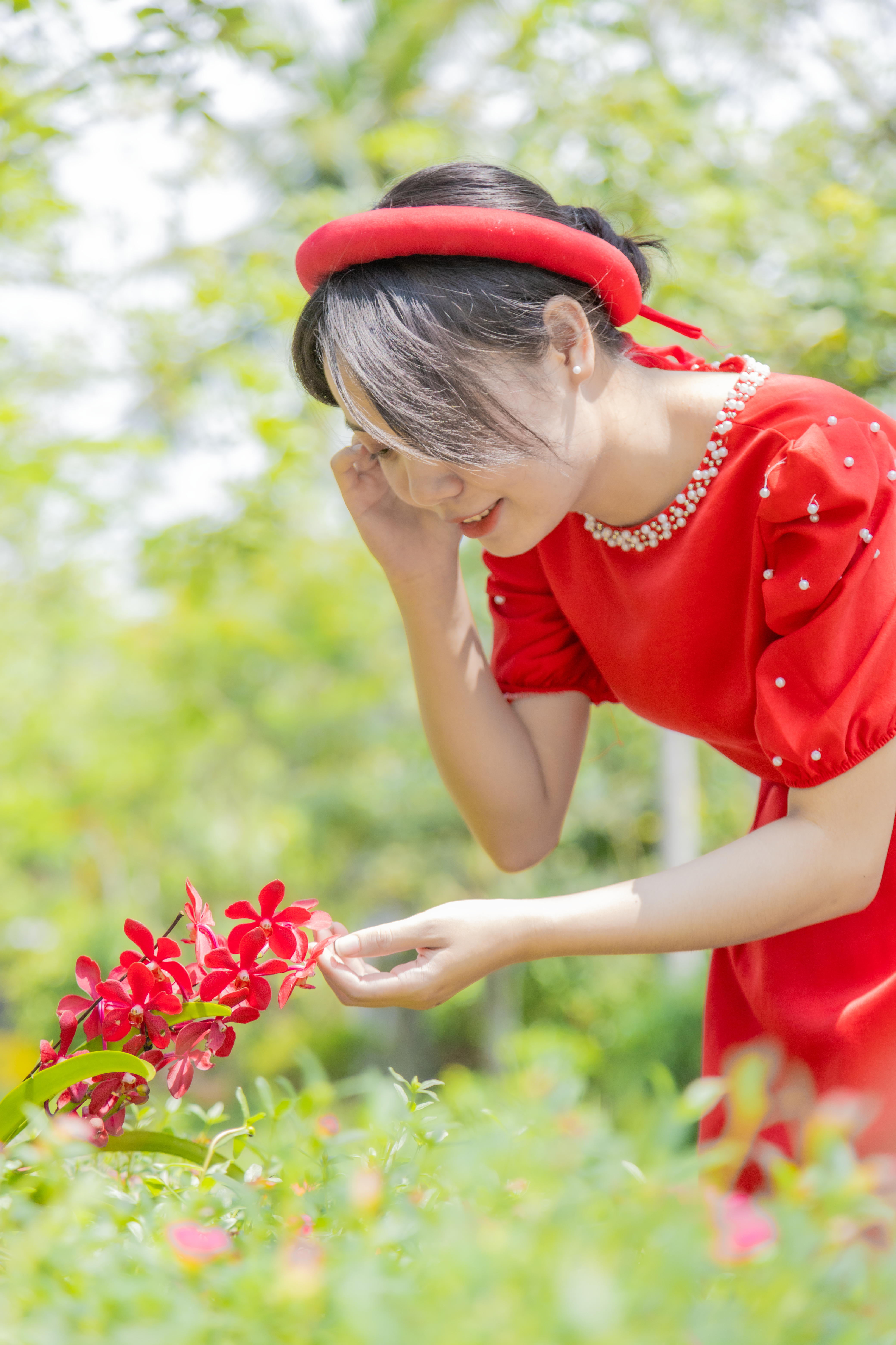 Woman in Red Dress Posing with Flowers · Free Stock Photo
