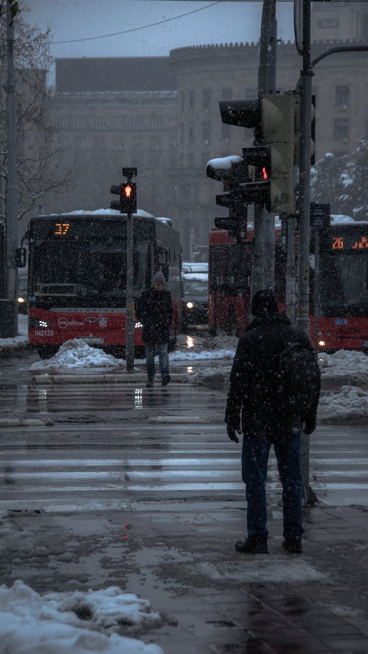 People Crossing Street In City In Winter