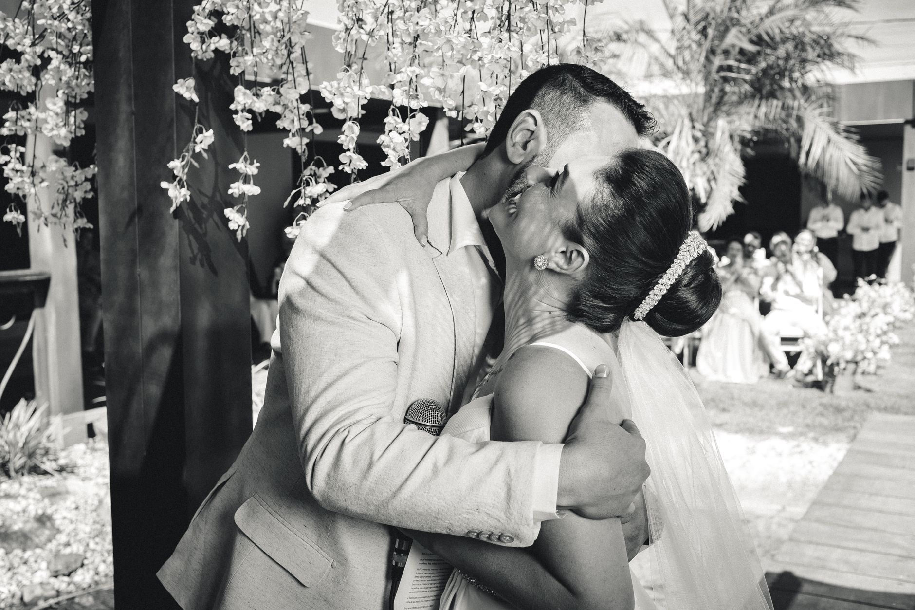 Bride and groom share a joyful embrace and kiss on their wedding day.
