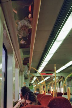 Commuters relax in a city train, capturing urban travel atmosphere.