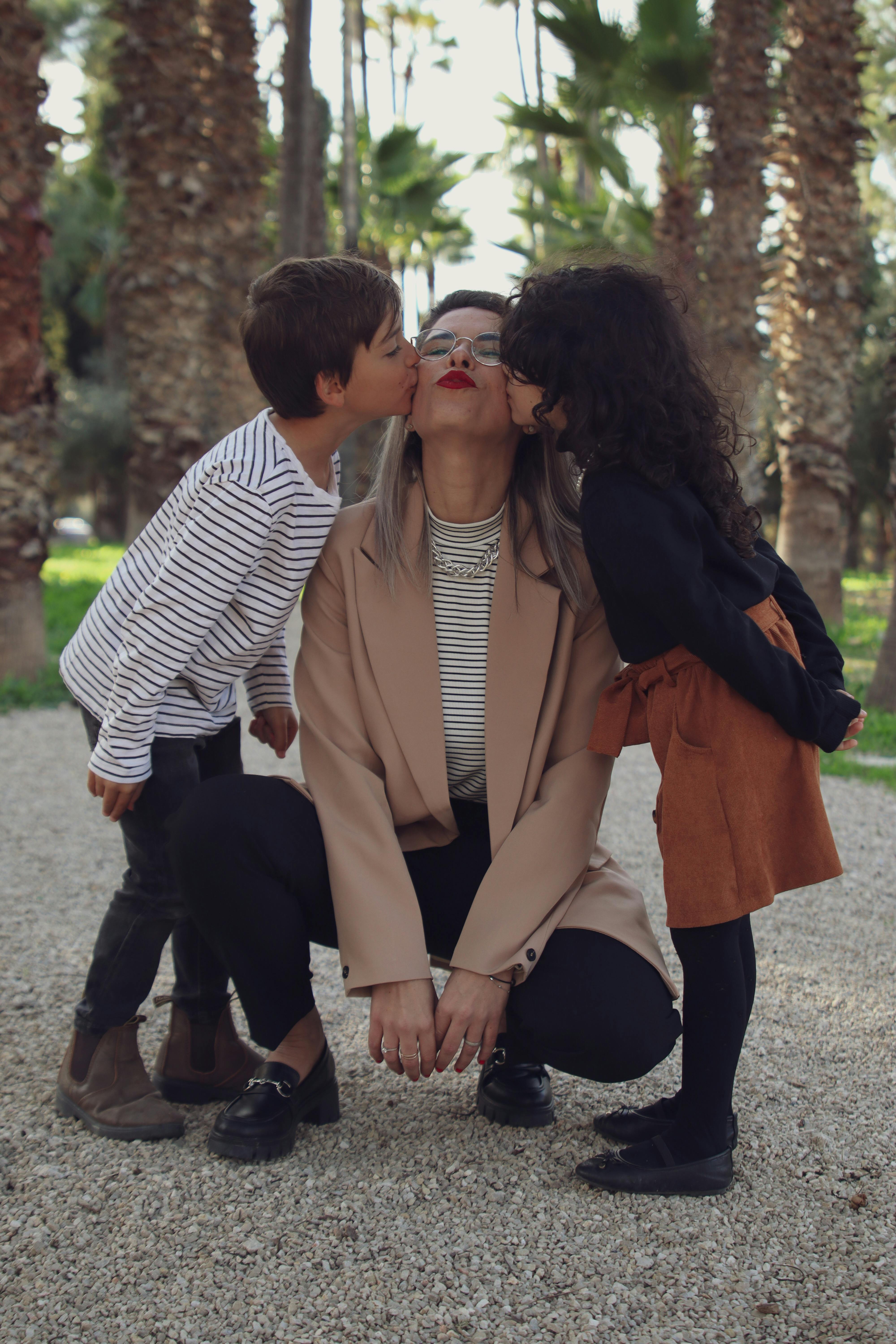 Little Boy and a Girl Kissing their Mother · Free Stock Photo