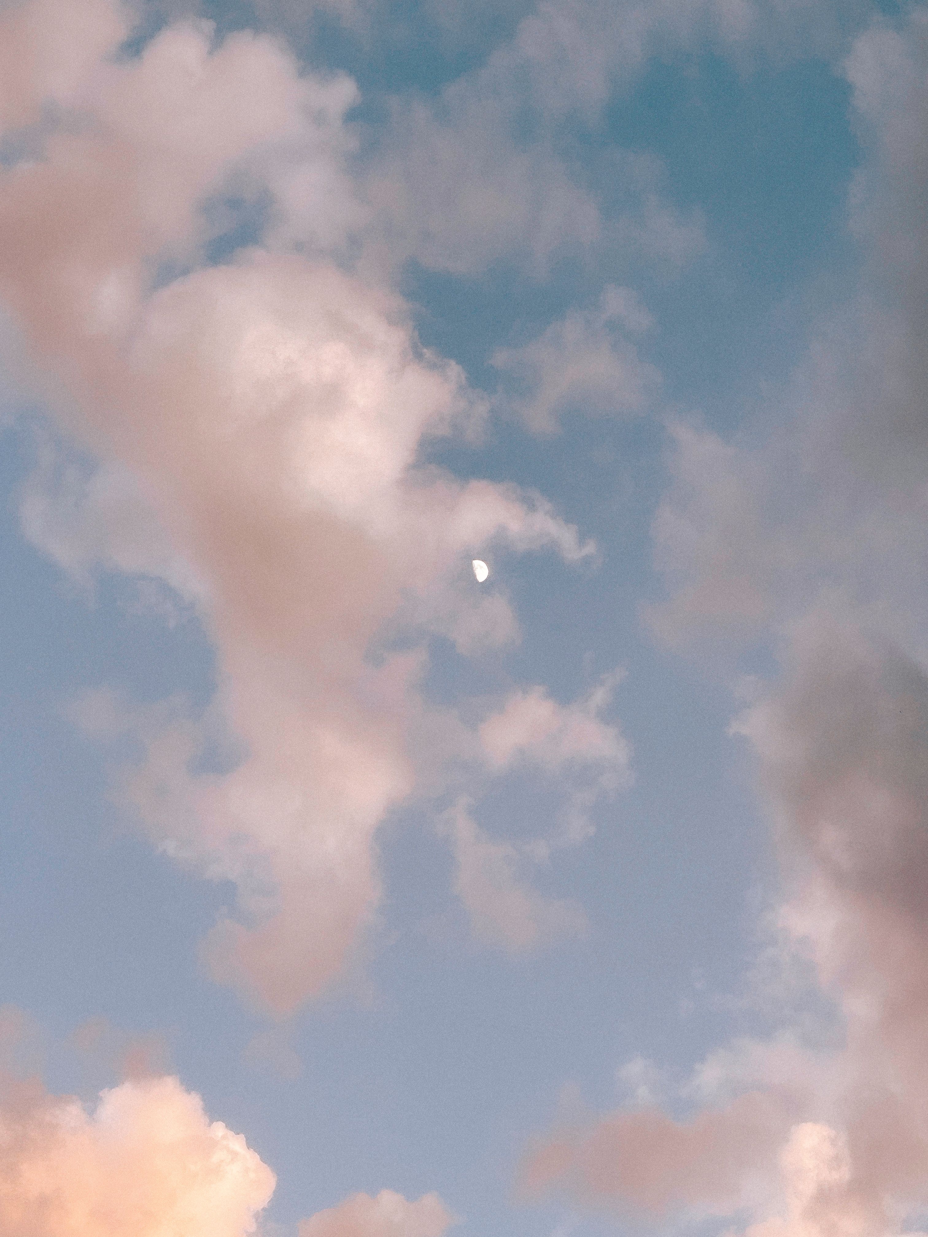 Moon among Fluffy White Clouds in Daylight · Free Stock Photo
