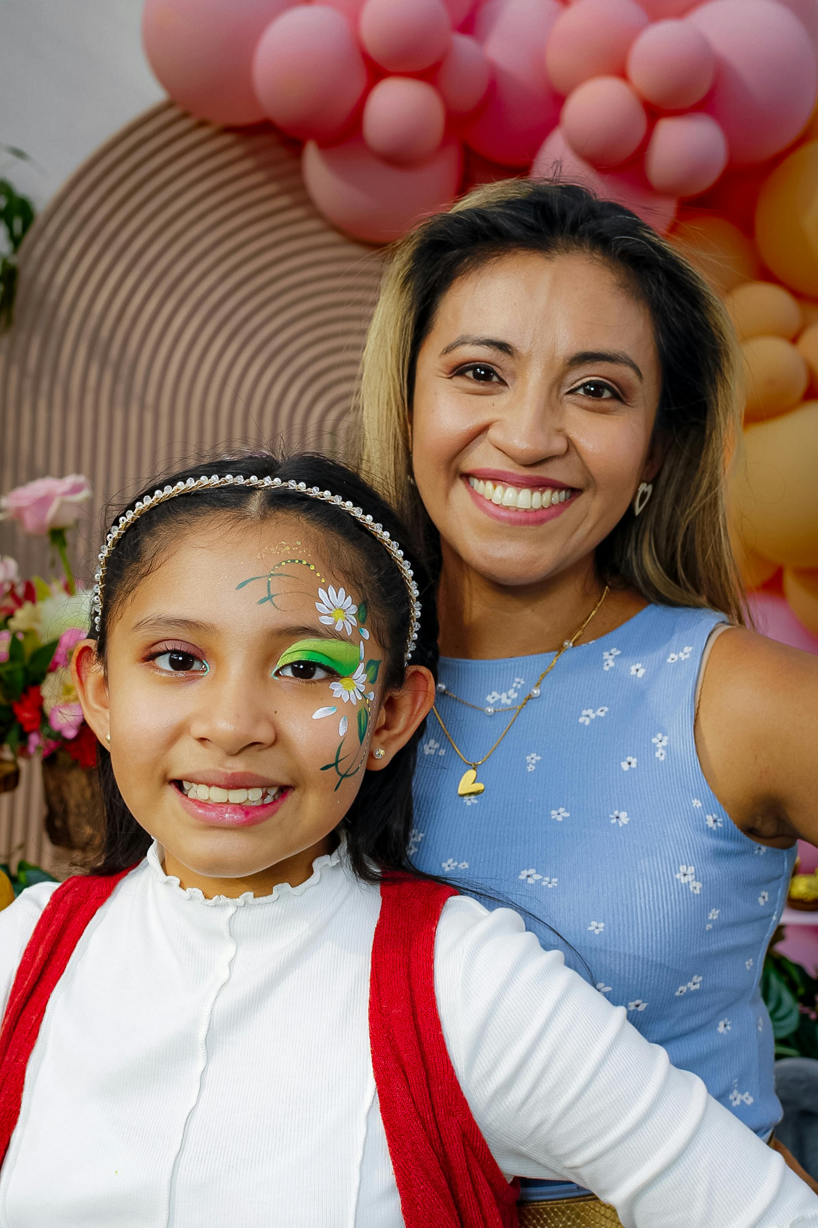 mother and daughter posing together