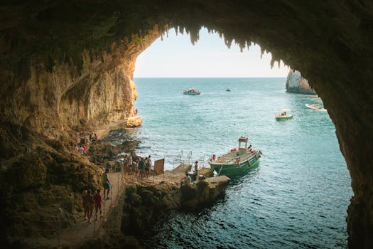 Tourists enjoying a boat tour inside the scenic Grotta Zinzulusa in Castro, Italy.