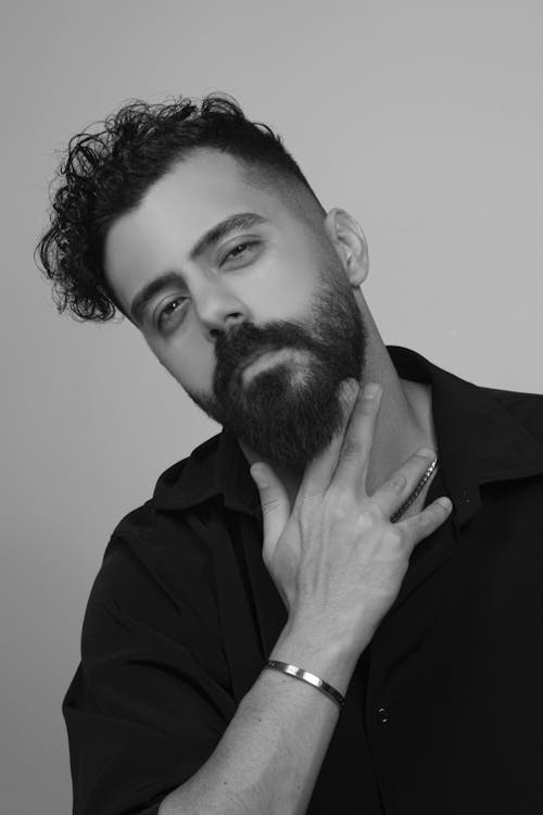 Handsome Man in Shirt with Hand in Beard