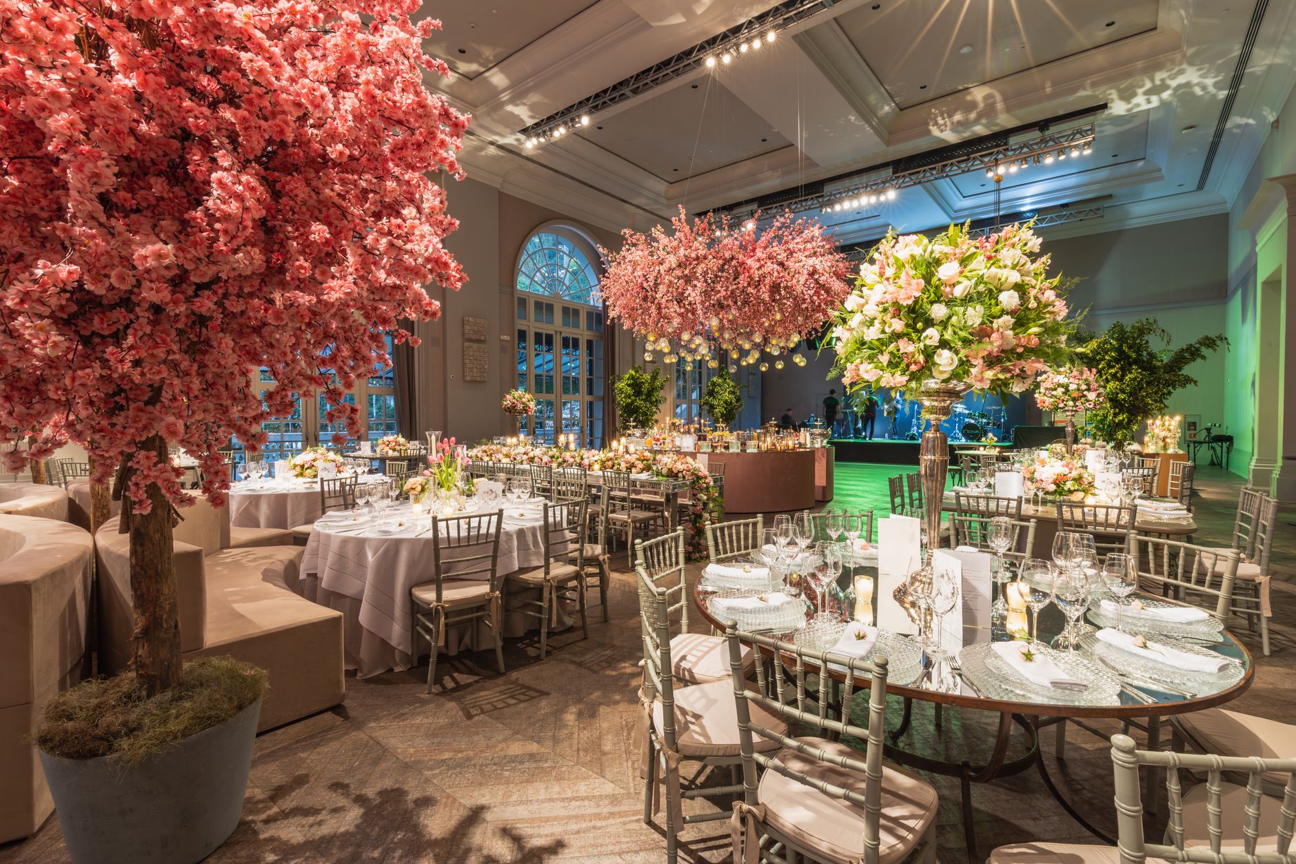 Luxurious wedding hall featuring elaborate floral arrangements and elegant table settings.