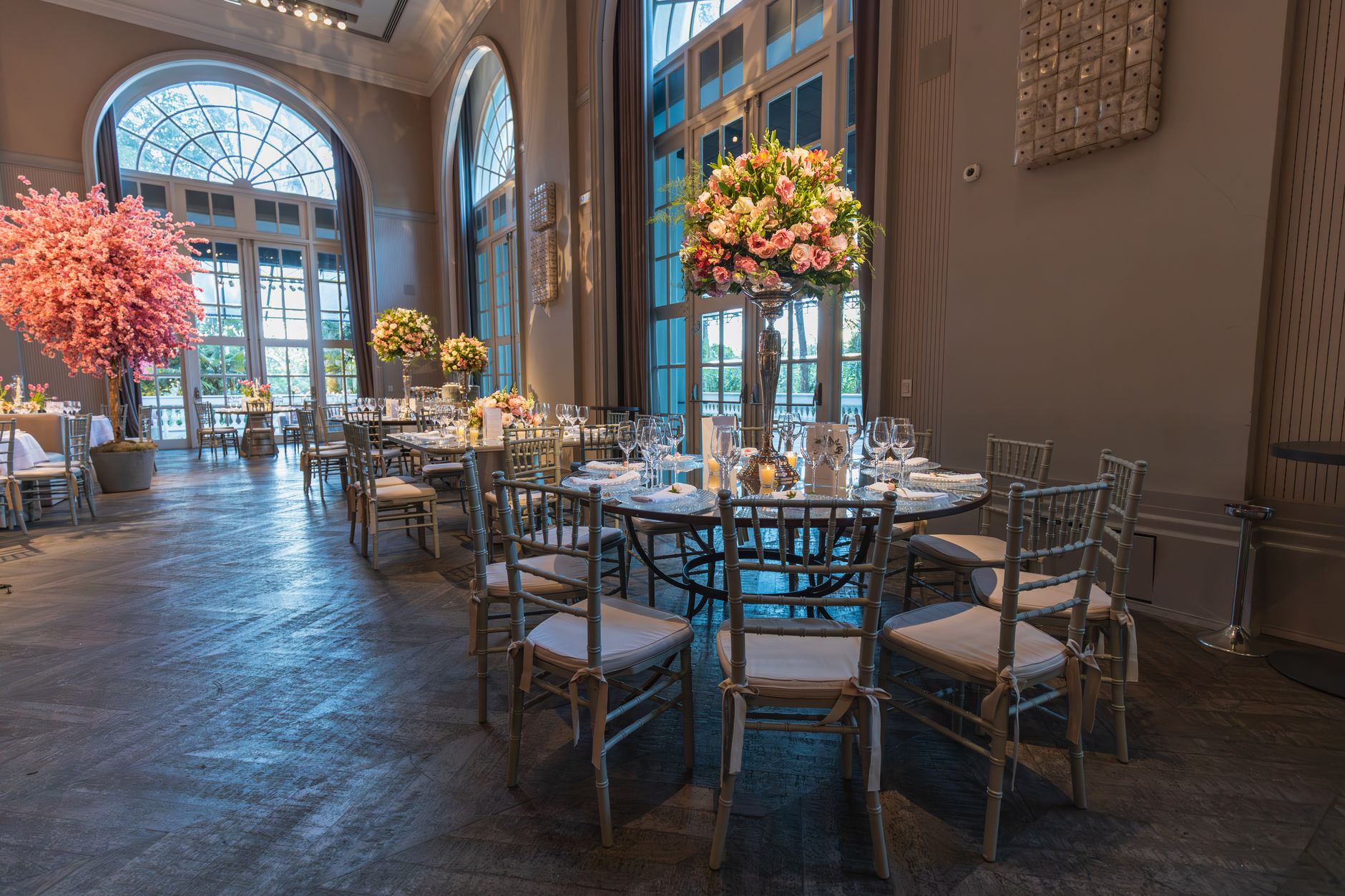 Luxurious wedding reception hall featuring floral arrangements and spacious interior ambiance.