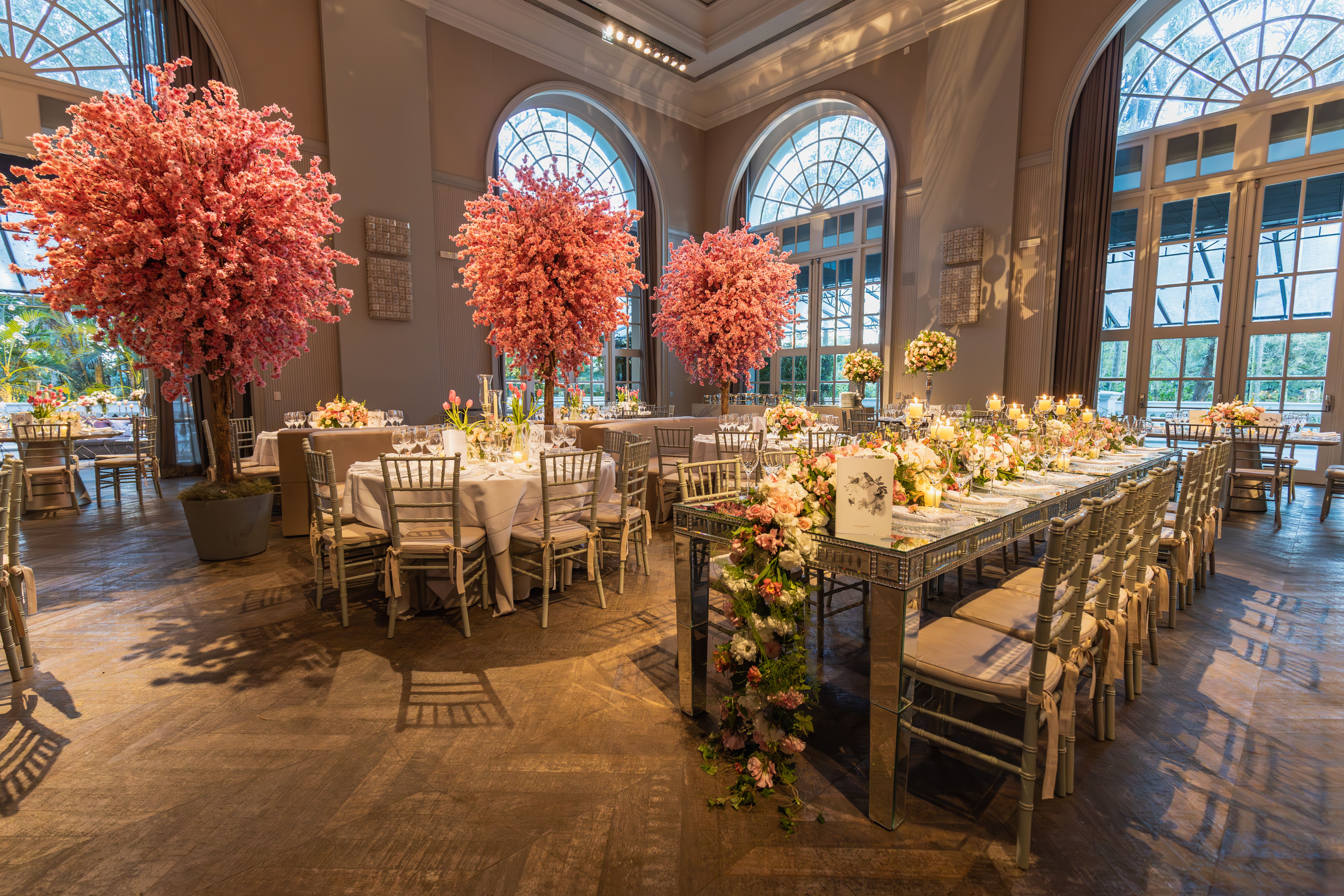 A luxurious wedding reception setting with elegant floral decorations and stylish table arrangements.